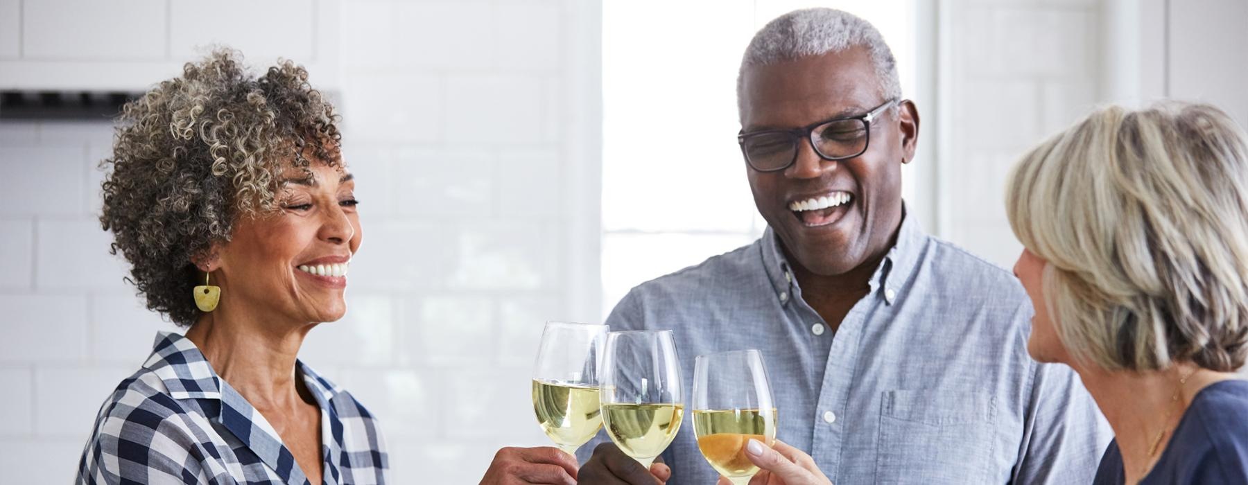 a few people holding wine glasses