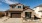 large brown house with a driveway