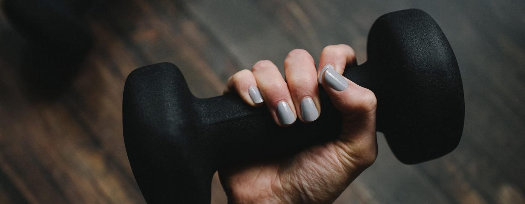 a person's hand holding a black object