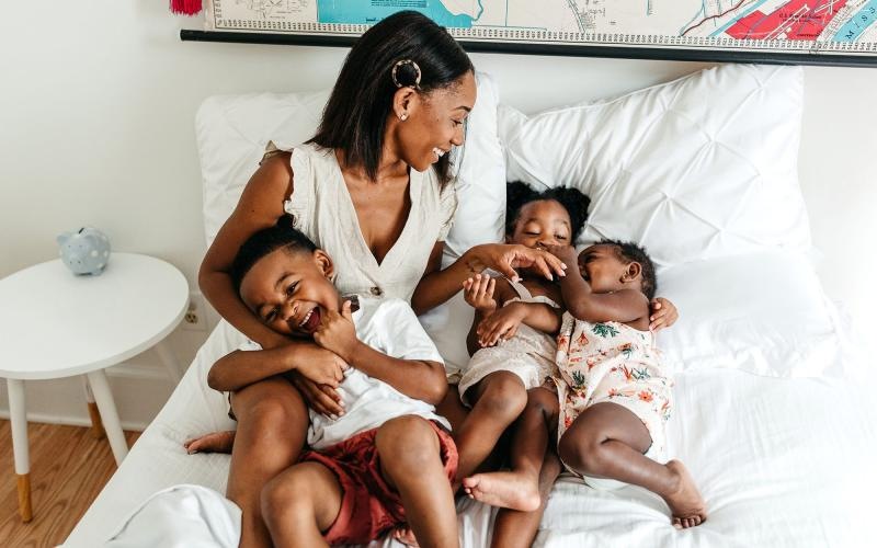 a woman holding a group of babies